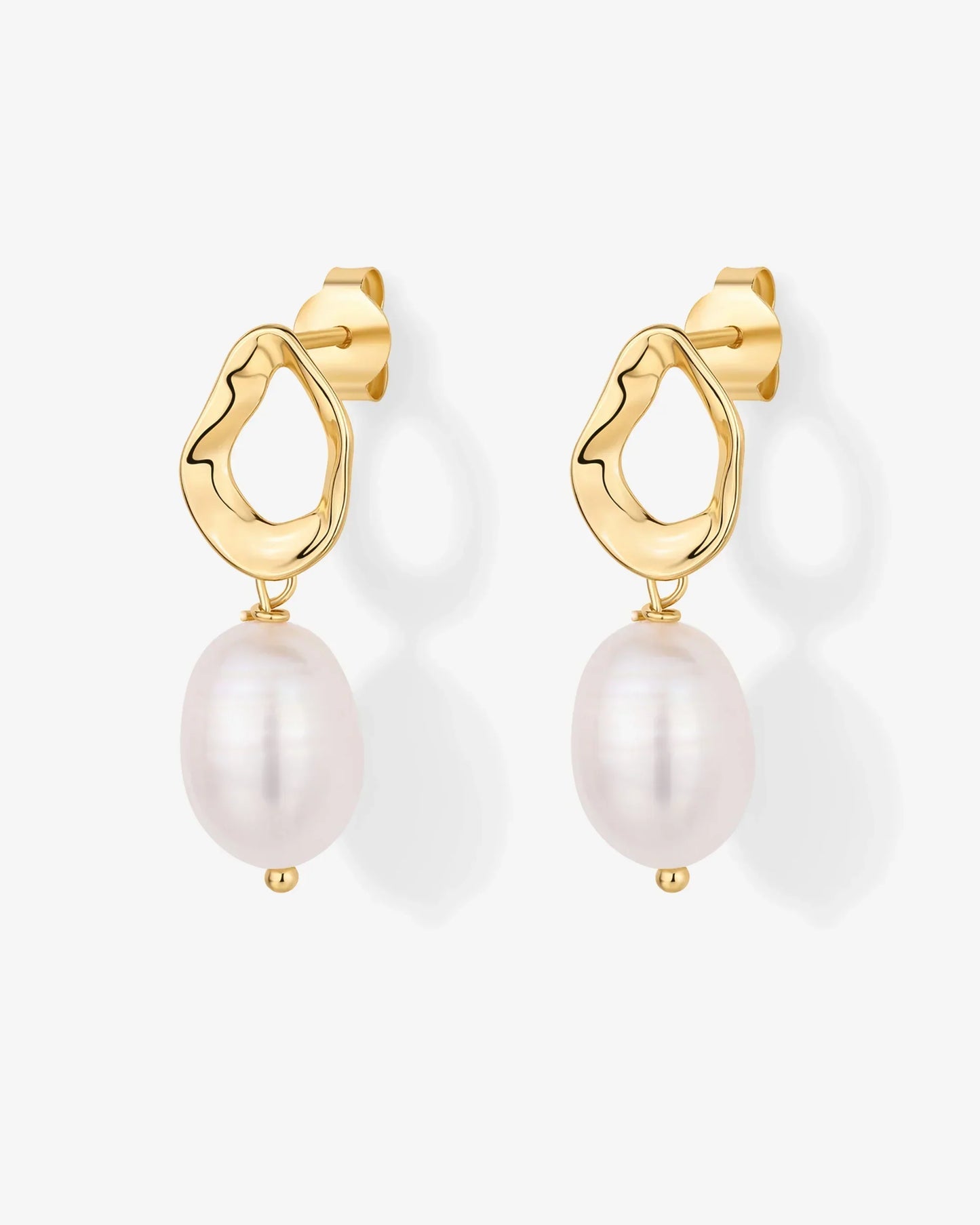 Pearl drop earrings with lustrous pearls in a gold metal setting.