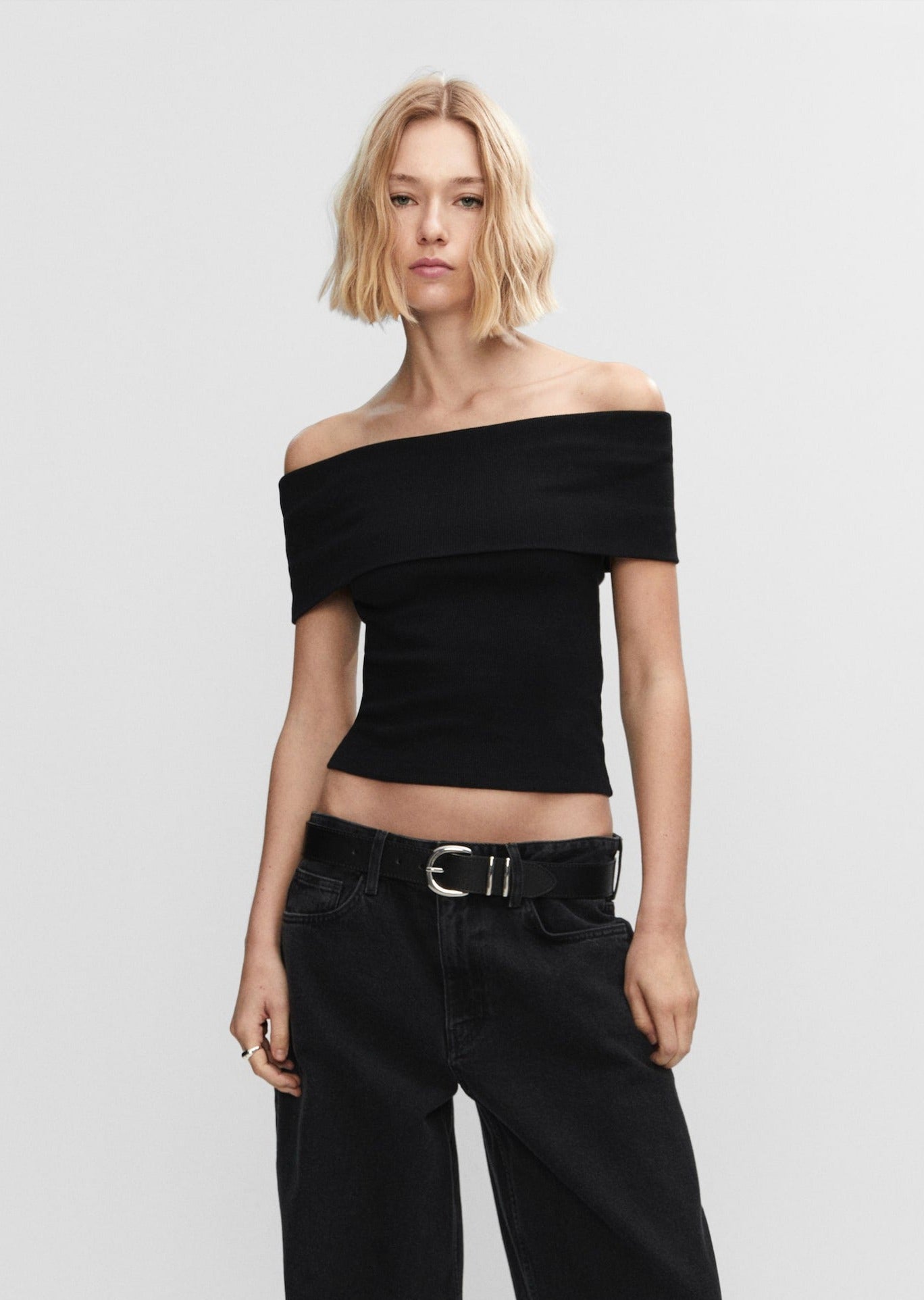 Short sleeve off shoulder top in black, fitted silhouette, lightweight fabric.