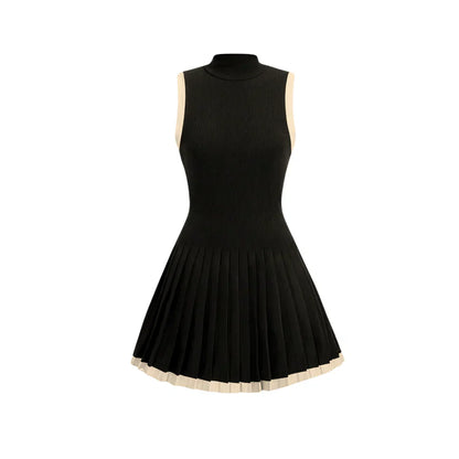 Sleeveless black knit mini dress with high neckline, pleated skirt, and contrasting trim.