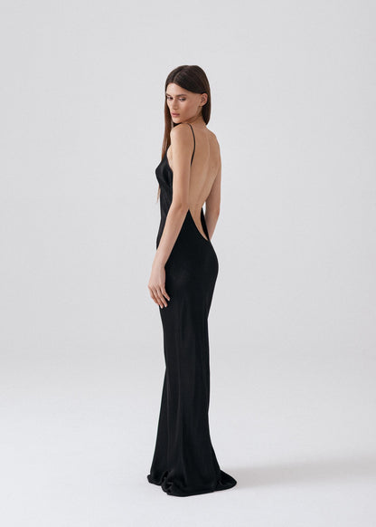 Elegant black silk maxi dress with thin straps and open back, ideal for evening events.