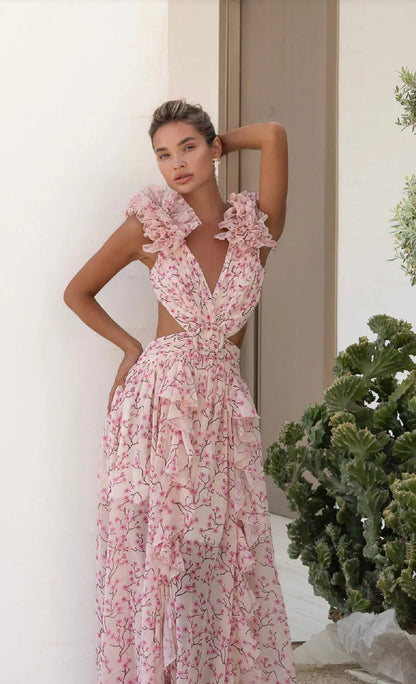 Elegant floral chiffon maxi dress with ruffled cap sleeves and plunging V-neckline.