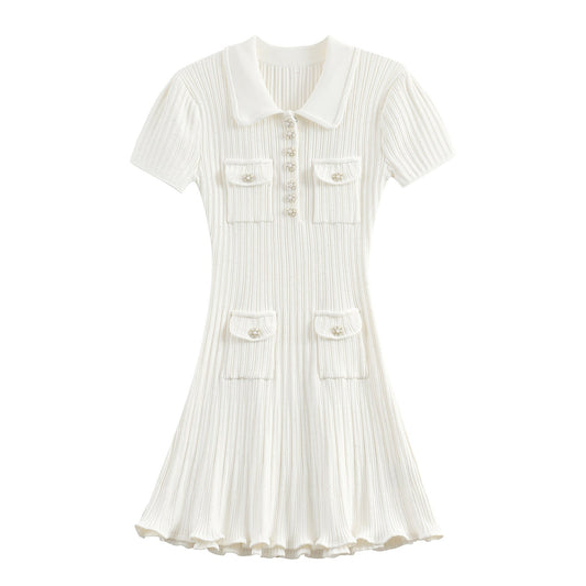 Clara Knit Mini Dress with ribbed texture, collared neckline, pearl-accented buttons, and front pockets in soft neutral tone.