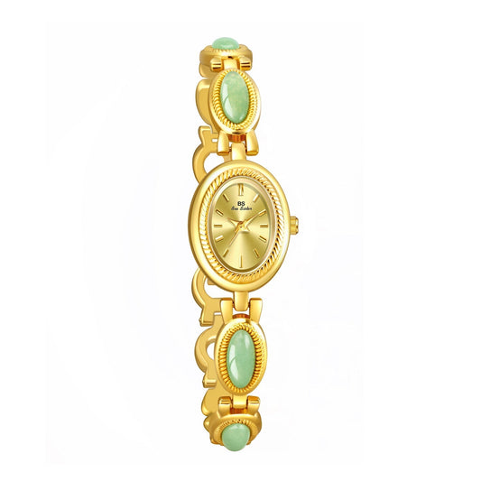 Gilded Eternity dainty vintage watch with gold-tone bezel and green stone accents.