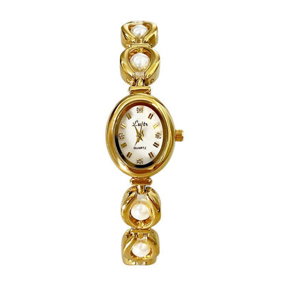 Vintage pearl watch with gold-tone bracelet and mother-of-pearl dial.