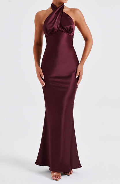 Esmeralda Backless Burgundy Maxi Dress with halter neckline and floor-length skirt.