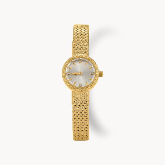 Golden Whisper Vintage women's watch with silver and gold-tone design, textured bracelet, and crystal accents.